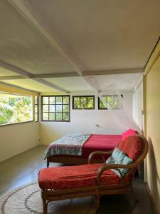 1 dormitorio con 2 camas, banco y ventanas en Maui Homestay en Tohautu