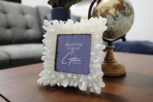 a picture frame on a table next to a globe at Stylish Retreat with King Bed, Long Stays, WEM, Disney+ in Edmonton