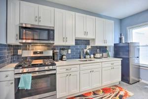 a kitchen with white cabinets and a stove top oven at Luxury Home in Linden