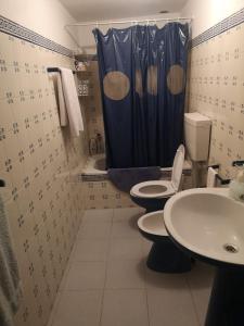 a bathroom with two toilets and a shower curtain at Giacometti Alentejo Peroguarda His last Desire in Peroguarda