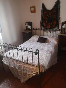 a bedroom with a bed with a white comforter at Giacometti Alentejo Peroguarda His last Desire in Peroguarda