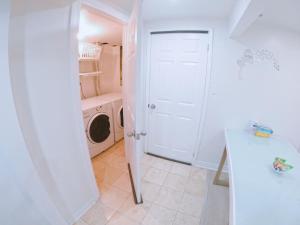 a white laundry room with a washer and dryer at Private, Spacious Apt Suite w/ Deck Free Parking in Mississauga