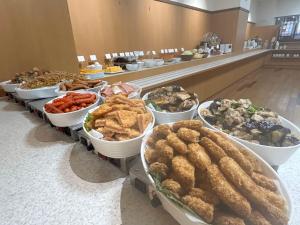 a buffet of different types of food on a counter at Hotel Alpha-One Tottori in Tottori
