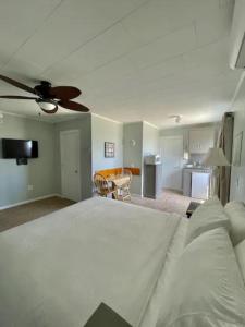 a bedroom with a large bed with a ceiling fan at Echo Motel in Old Orchard Beach