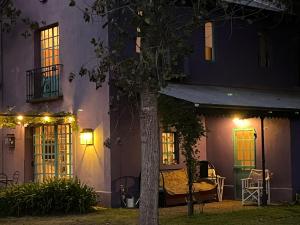 a night view of a house with a bed on the porch at Capilla-Casa de campo in Capilla del Señor