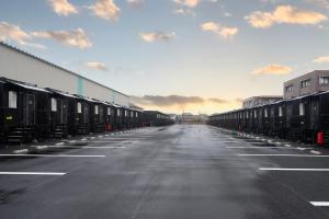an empty parking lot with rows of cars at HOTEL R9 The Yard 松阪 in Matsuzaka