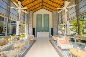 a rendering of the lobby of a resort with tables and chairs at Bhu Nga Thani Resort & Villas Railay in Railay Beach