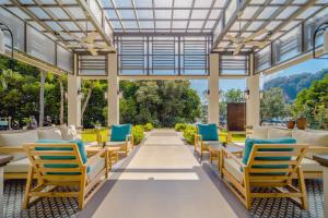 an outdoor patio with chairs and tables and a glass ceiling at Bhu Nga Thani Resort & Villas Railay in Railay Beach