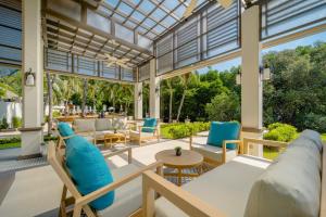 a conservatory with a couch and chairs and a table at Bhu Nga Thani Resort & Villas Railay in Railay Beach