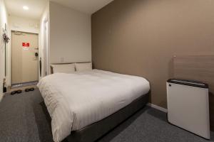 En eller flere senger på et rom på HOTEL R9 The Yard Matsusaka