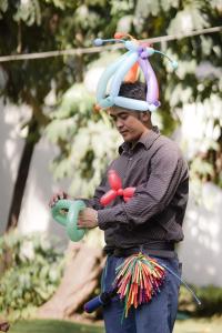 a man with a hat on his head holding toy items at Sofitel Philippine Plaza Manila in Manila