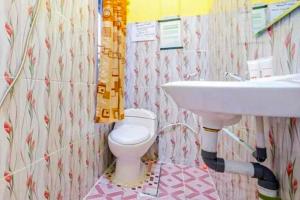 a bathroom with a sink and a toilet at Hotel Alam Lestari RedPartner in Palembang