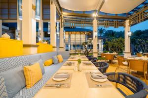a dining room with a long table and chairs at Bhu Nga Thani Resort & Villas Railay in Railay Beach