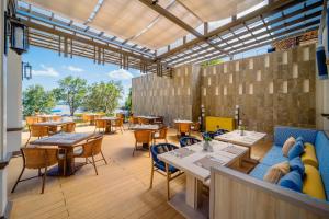 a restaurant with tables and chairs on a patio at Bhu Nga Thani Resort & Villas Railay in Railay Beach