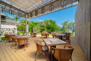 an outdoor patio with tables and chairs at Bhu Nga Thani Resort & Villas Railay in Railay Beach