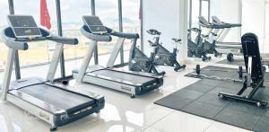 a gym with several cardio machines in a room at Ina apartment - Nera garden Hue in Hue