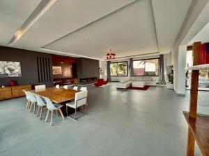 a large living room with a wooden table and chairs at Villa Dar El Hna in Marrakesh