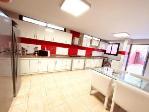 a kitchen with a glass table and a refrigerator at Villa Dar El Hna in Marrakesh