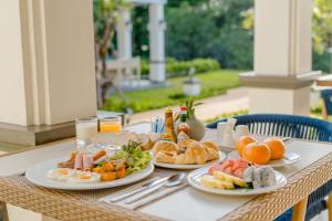 a table with three plates of food on it at Bhu Nga Thani Resort & Villas Railay in Railay Beach