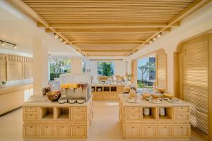 a large kitchen with wooden cabinets and a counter top at Bhu Nga Thani Resort & Villas Railay in Railay Beach