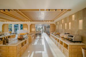 a large kitchen with wooden cabinets and counters at Bhu Nga Thani Resort & Villas Railay in Railay Beach