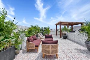 a patio with chairs and a gazebo at Elena Villa by Betterplace in Tanah Lot