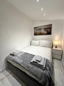 a bedroom with a bed with towels on it at Central London Zone 1 apartment in London