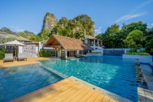 a swimming pool with a gazebo and a house at Bhu Nga Thani Resort & Villas Railay in Railay Beach