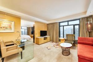 a hotel room with a bed and a desk at The Westin Bund Center, Shanghai in Shanghai