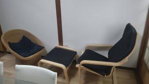 three chairs with blue cushions sitting in a room at Kami House Annex in Osaka