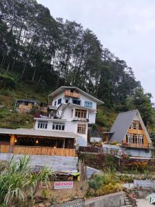 a large white building on top of a hill at Zangmo Lee Baam Rezay gangtok Sikkim in Gangtok