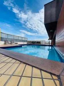 a swimming pool on the roof of a building at Brisa Mar in Vila Velha