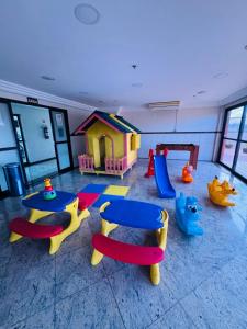 a childrens play room with a table and play equipment at Brisa Mar in Vila Velha
