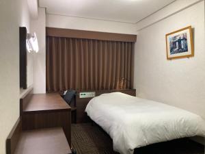 Postel nebo postele na pokoji v ubytování Hotel Alpha-One Ogori