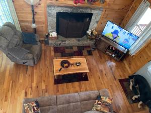 an overhead view of a living room with a flat screen tv at Alpenhaus Cabins Real Log Home in Helen Ga Mountains with hot tub and balconies in Sautee Nacoochee
