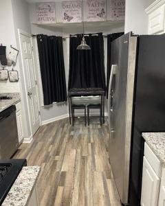 a kitchen with a chair and a refrigerator at Pressure Pad in College Park