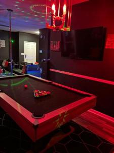 a pool table in a room with red lighting at Pressure Pad in College Park