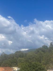 un cielo azul con nubes sobre una montaña en MAGICO APARTA ESTUDIO BELEN FATIMA, en Medellín