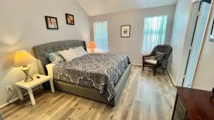 a bedroom with a bed and a table and a chair at David &Jennie’s Place I in Missouri City