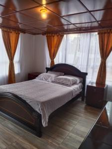 a bedroom with a large bed with a canopy at Hotel Campestre Mirador De San Nicolas in Ubaque