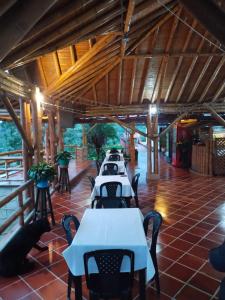 a row of tables and chairs in a building at Hotel Campestre Mirador De San Nicolas in Ubaque