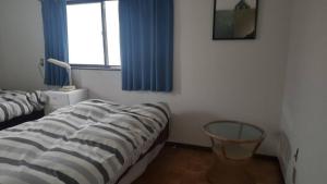 a bedroom with a bed and a window and a mirror at Kami House Annex in Osaka +6 photos