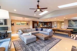 a living room with a couch and a pool table at Sumptuous Coastal Hideaway in Oceanside