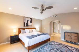 a bedroom with a bed and a ceiling fan at Sumptuous Coastal Hideaway in Oceanside