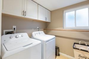 a laundry room with a white washer and dryer at Sumptuous Coastal Hideaway in Oceanside +21 photos