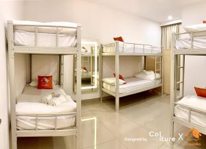 a room with four bunk beds with white pillows at 30-80 pax Private Event Venue - Sunset Paradise by Cowidea in Masai