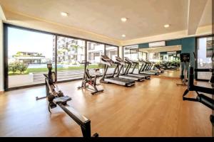 a gym with rows of treadmills and elliptical machines at Ensueño en Nuevo Vallarta in Nuevo Vallarta 