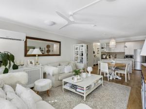 a living room with a couch and a table at ULTIQA Burleigh Mediterranean Resort in Gold Coast