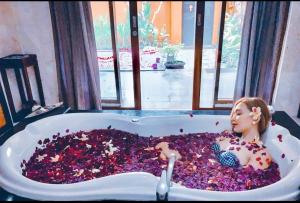 a doll sitting in a bath tub filled with debris at One Bedroom Private Villa Kuta in Seminyak
