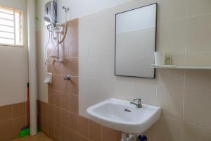 a bathroom with a sink and a mirror at Adno Homestay Seroja#3BR#5 Single#IKEA#High Speed Wifi#5pax in Simpang Ampat